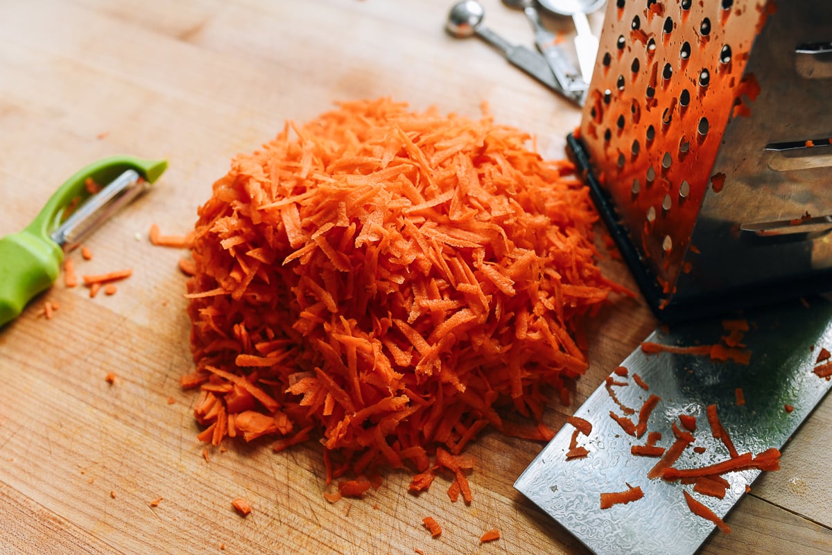 grating carrot on box grater