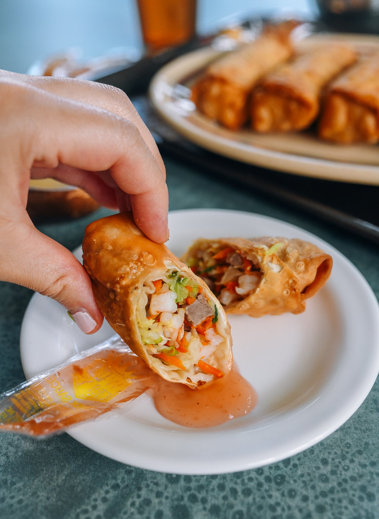 dipping egg roll in duck sauce