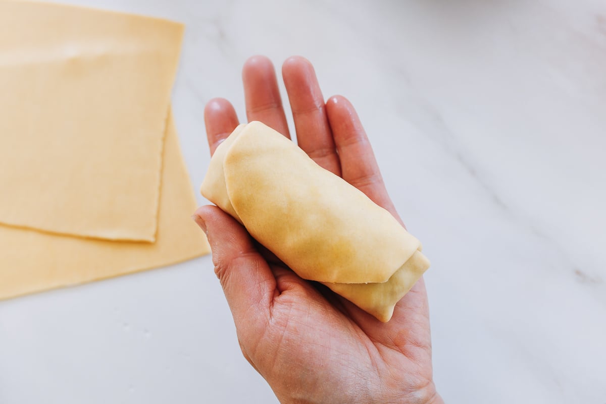 holding an assembled egg roll