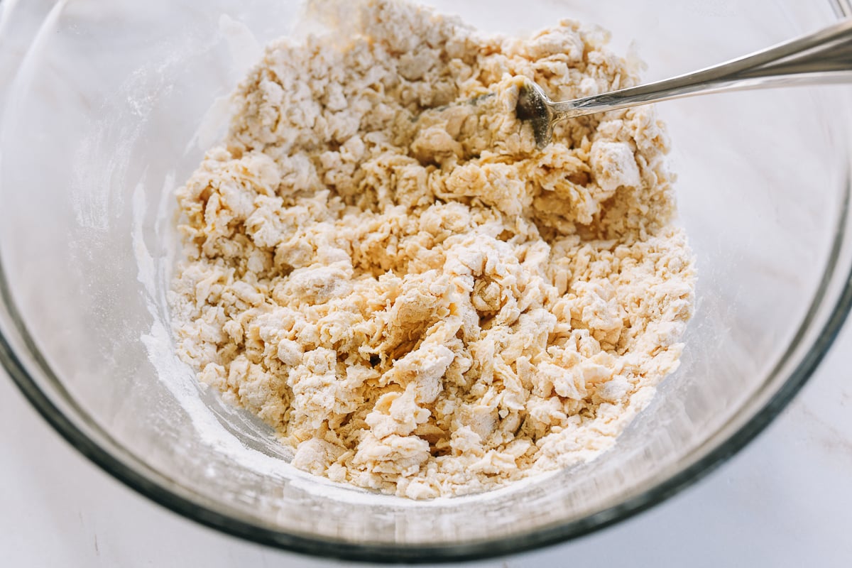 combining flour, water, egg yolk