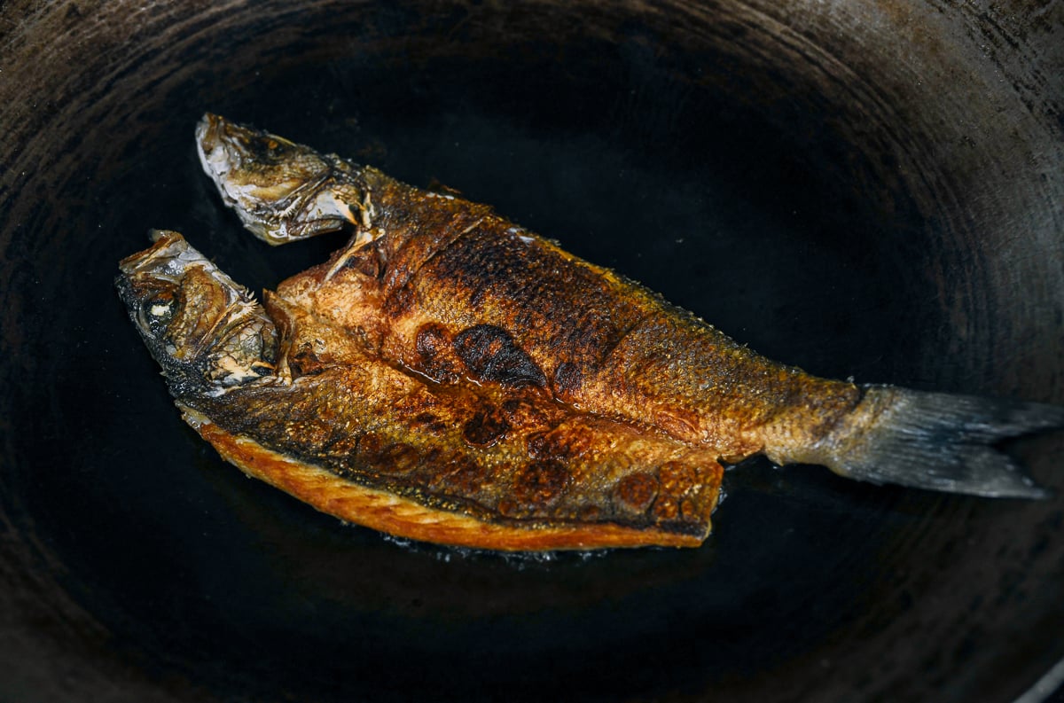 pan-fried butterflied fish in wok