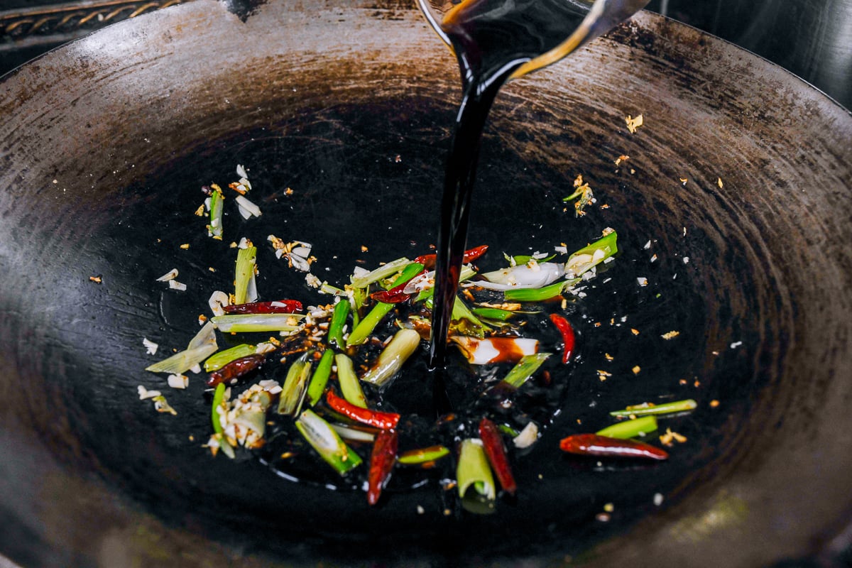pouring sauce mixture into wok