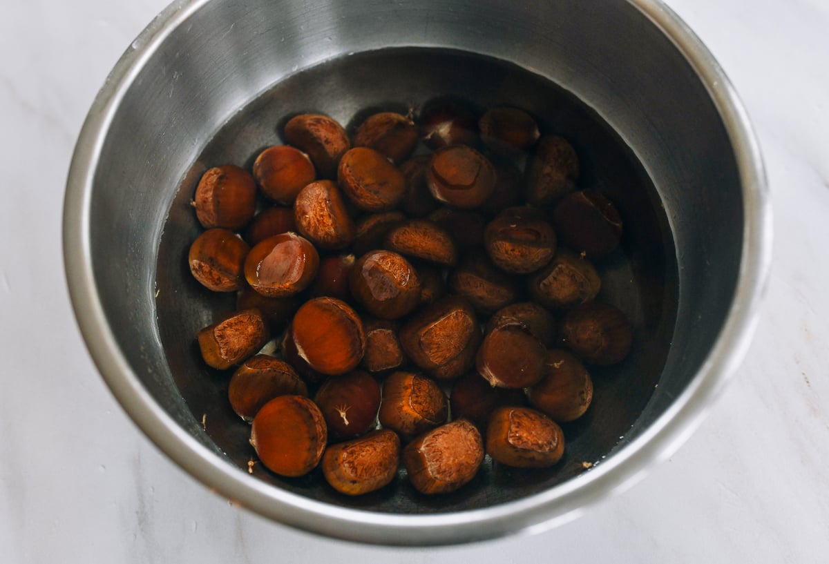 soaking chestnuts in bowl of water